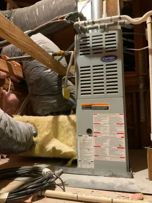Image of a heating system installed in an attic, showing insulation and ductwork, serviced by AIS Heating & Air Conditioning in Livermore.