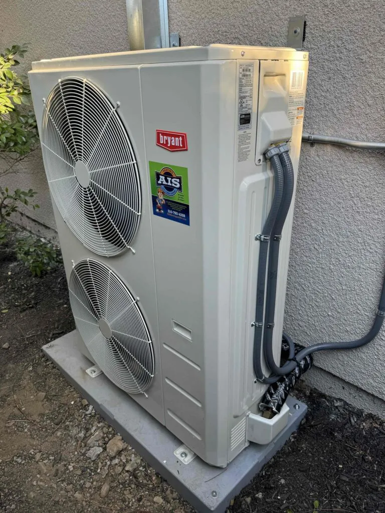 Outdoor HVAC unit labeled with AIS Heating & Air Conditioning in Livermore, featuring a large fan and multiple cables connected.
