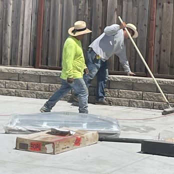 Two workers in hats from ARP Hardscape working on a concrete project in San Leandro.