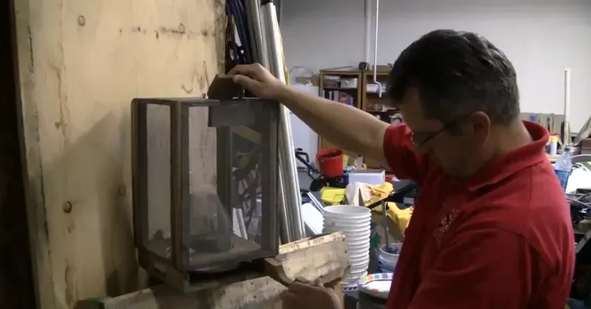 A person in a workshop setting inspecting a piece of equipment, representing ATCO Pest Control's methods in Petaluma.