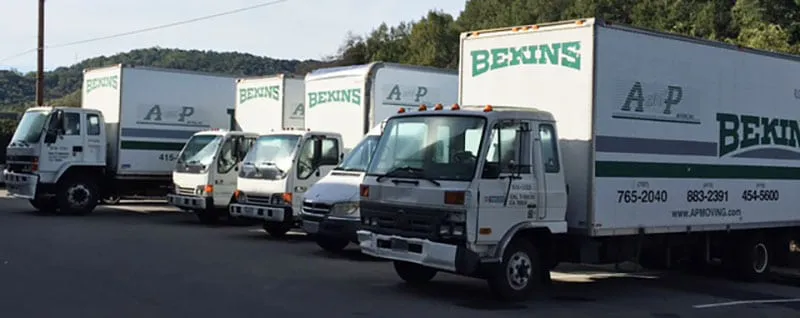 A fleet of A and P Moving, Inc. trucks parked in Novato, ready for moving services.