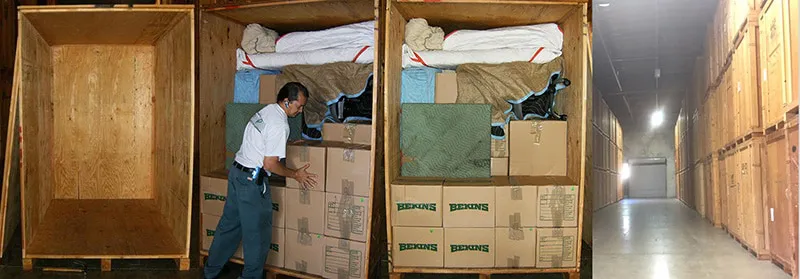 A worker organizing boxes and items in wooden storage units at A and P Moving, Inc.'s facility in Novato.