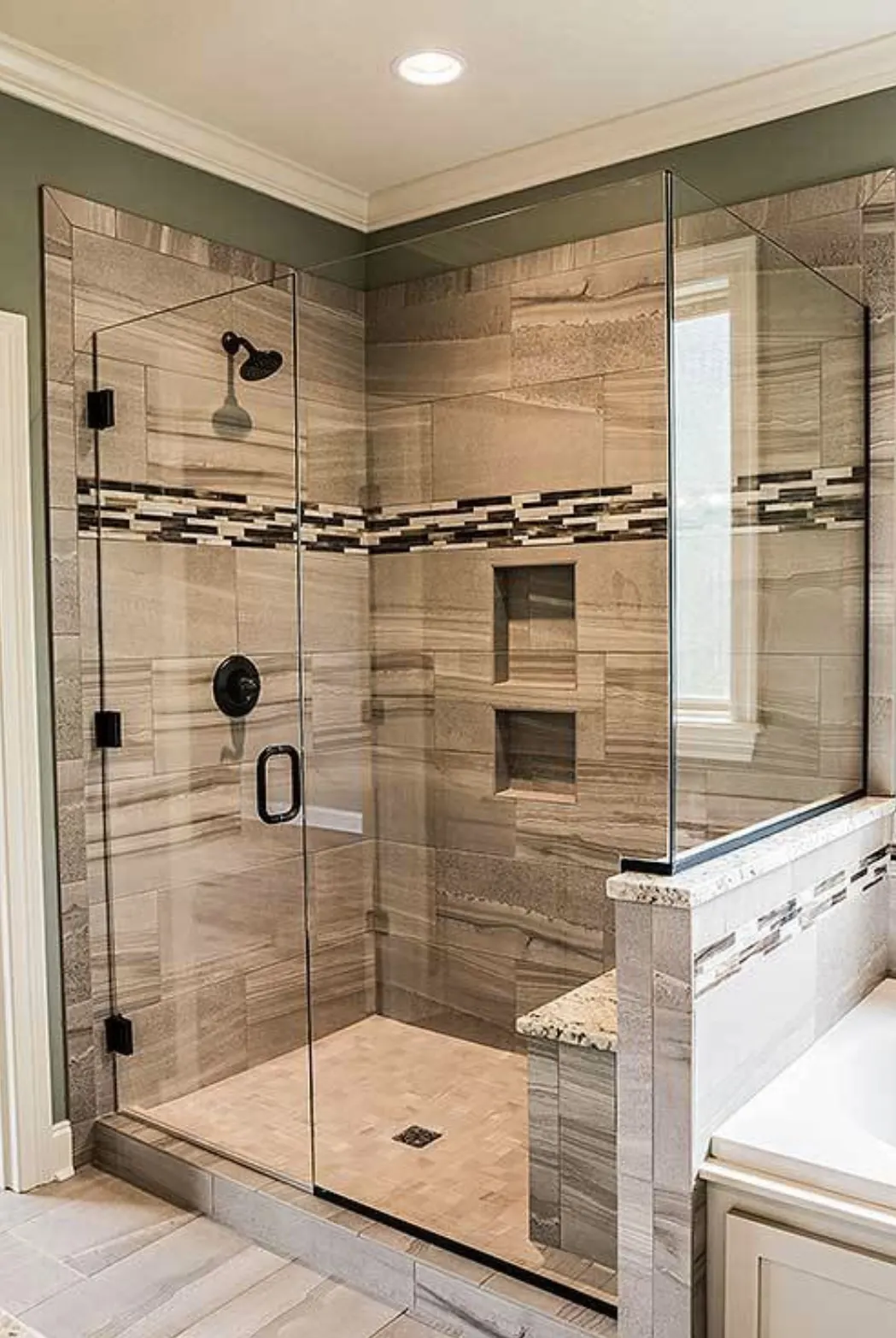 A modern glass shower enclosure with beige and brown tile work, featuring a sleek design, installed by Able Glass Company in Santa Clara.
