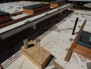 A flat roof under construction by Abril Roofing, Inc. in Martinez, featuring materials and structural details.