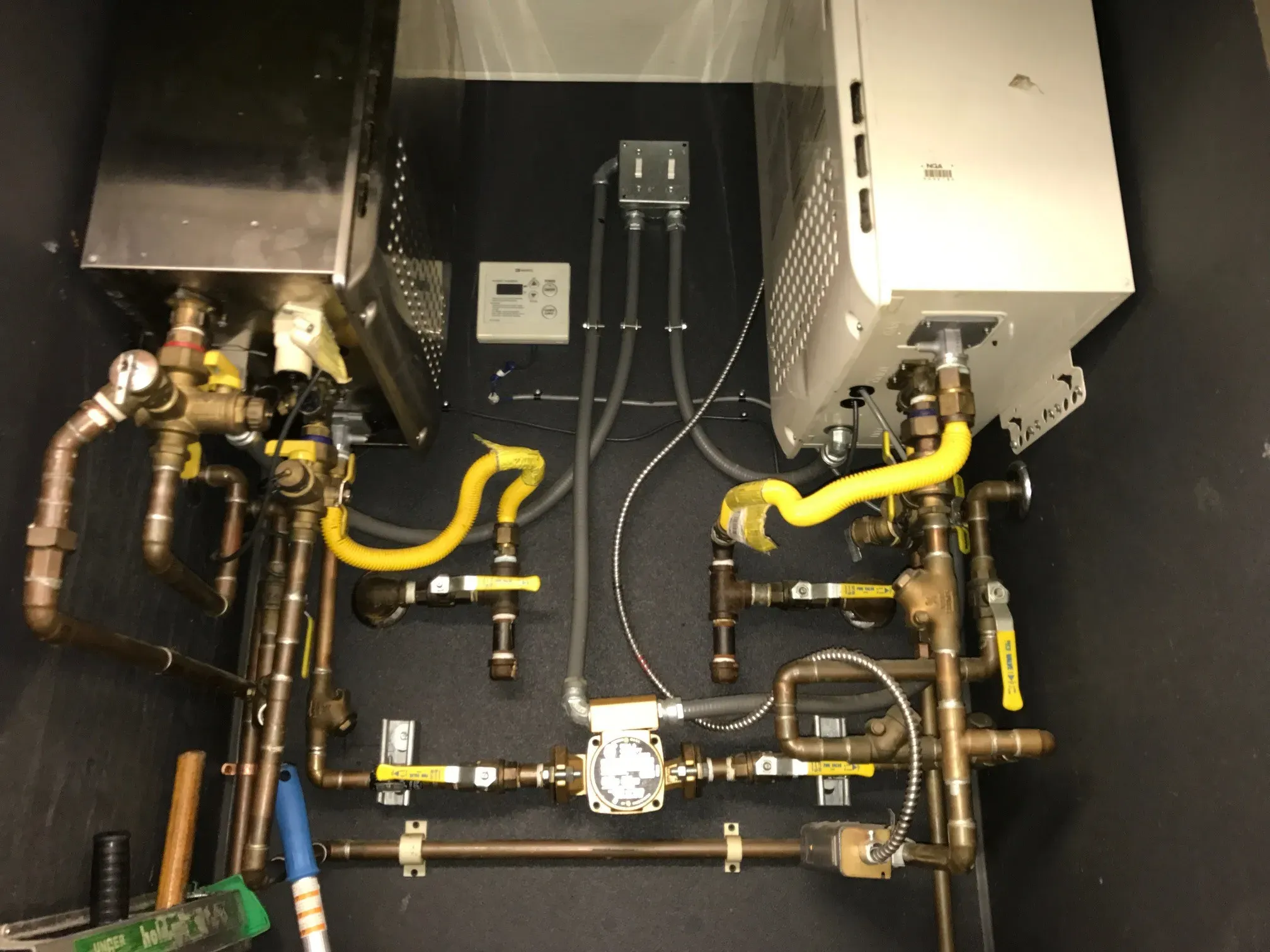 Image of a complex plumbing installation with various pipes and fittings, showcasing the professional work by AbsolutePlumbingandDrain in Concord.
