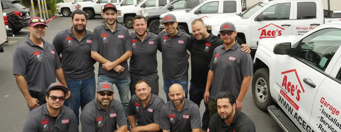 "Team of Ace's Garage Door Repair & Installation standing together in front of company trucks in Hayward."