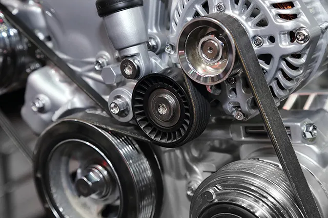 Close-up view of an engine's belt and pulley system at Acur-It Auto Repair in Rohnert Park, showcasing detailed mechanical components.