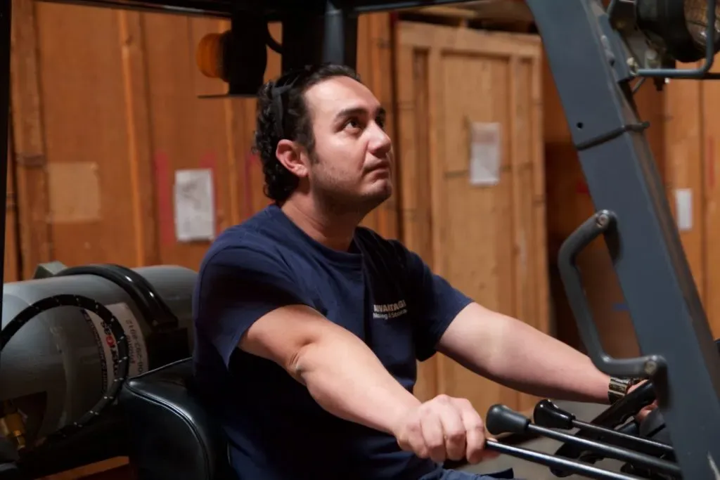 Man operating a forklift in a storage facility, representing Advantage Moving & Storage in Milpitas.