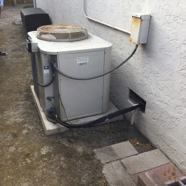 "An outdoor air conditioning unit installed next to a house, showcasing Air Care Heating & Cooling, Inc.'s services in San Jose."