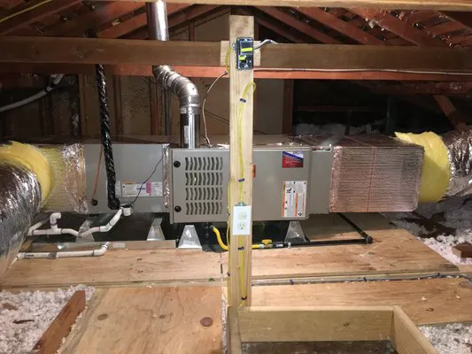 "An HVAC system installed in an attic by Air Care Heating & Cooling, Inc., showing ductwork and insulation in San Jose."