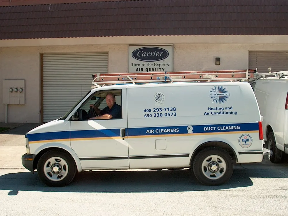 "A service van for Air Quality Heating & Air Conditioning parked in front of a building in San Jose, showcasing company branding and contact information."