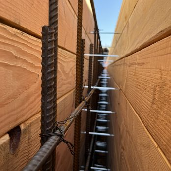 Close-up of rebar installation between wooden panels, demonstrating construction techniques by Alameda Engineering in Castro Valley.