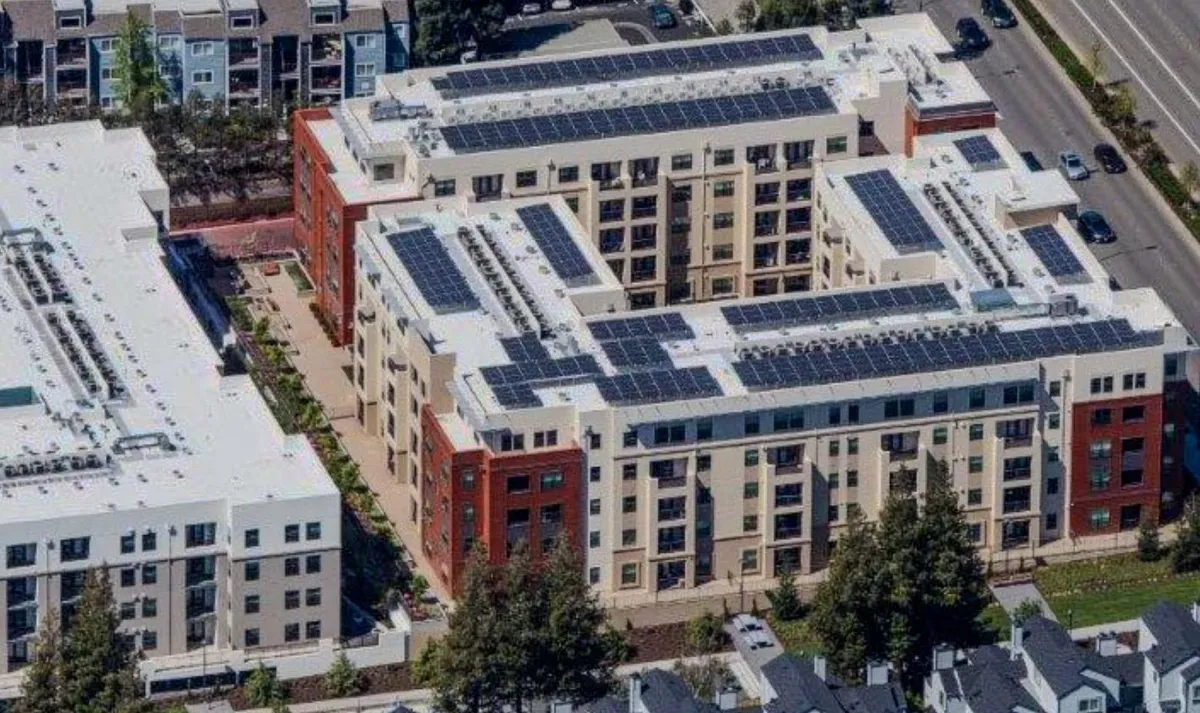 "Aerial view of a building complex in San Jose with solar panels installed on the roofs, completed by All Seasons Roofing & Waterproofing, Inc."