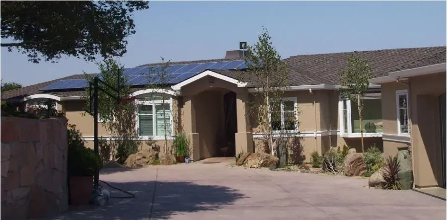 A home in San Jose with a well-maintained roof featuring solar panels, serviced by All Seasons Roofing & Waterproofing, Inc.