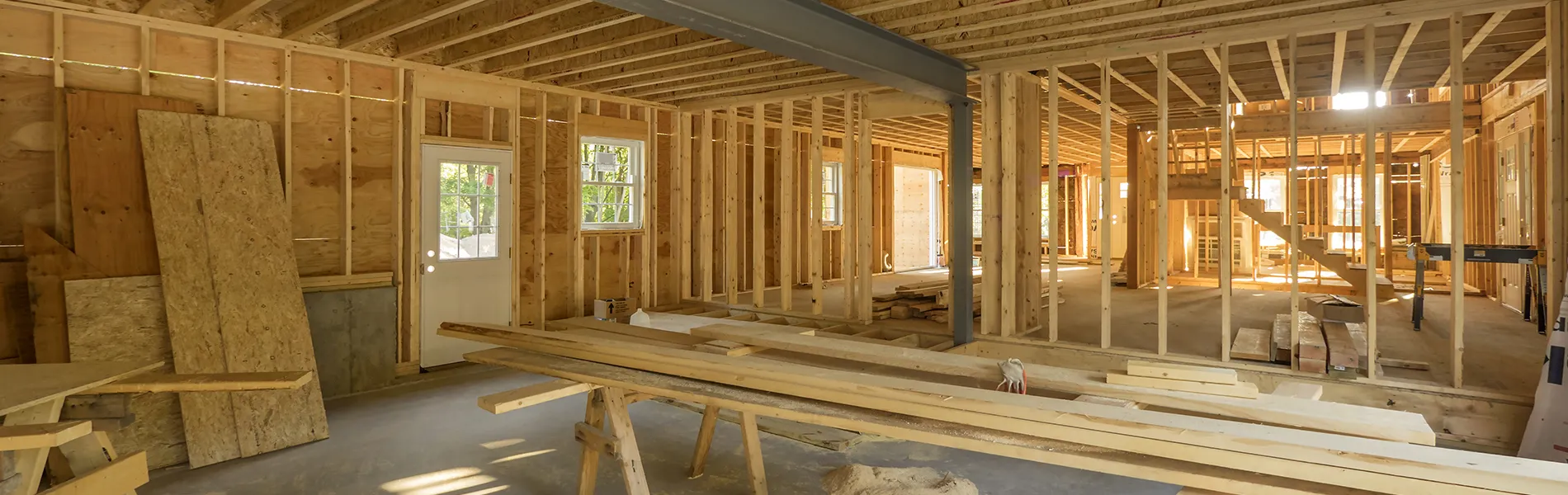 Interior of a building under construction with wooden framing and beams by Alltek Restoration, Inc. in Pittsburg.