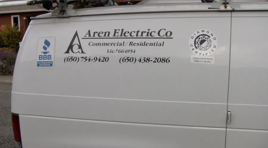 Image of a white van displaying the logo and contact information for Aren Electric Co., Inc., featuring certification badges and located in Daly City.