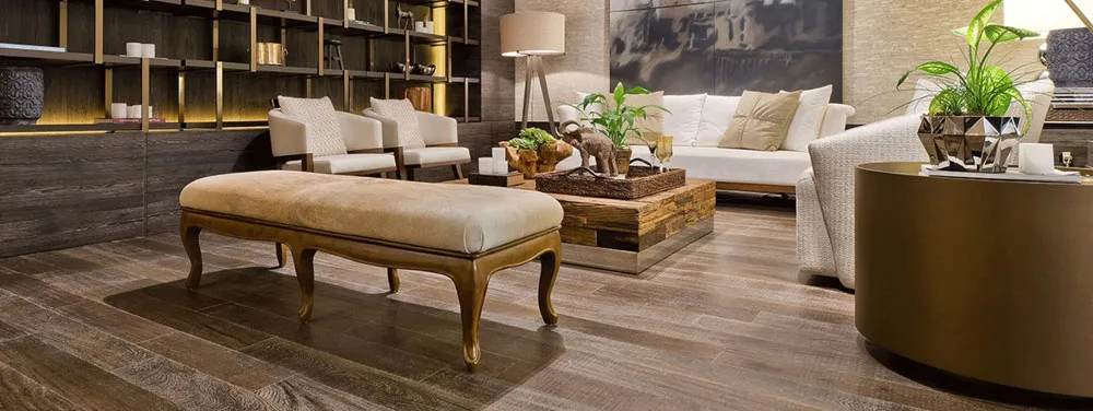 A beautifully furnished living room featuring high-quality linoleum flooring by Armstrong Carpet and Linoleum Company in San Francisco, with plush seating, a wooden coffee table, and decorative plants.