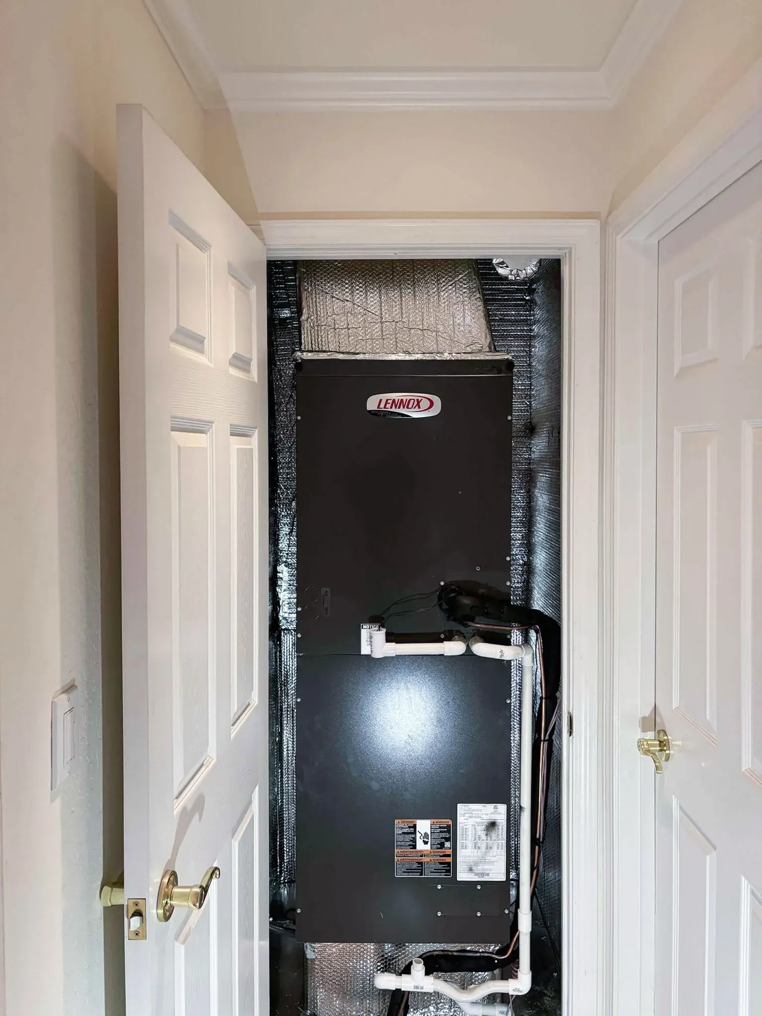 "A Lennox HVAC unit installed inside a closet, demonstrating Art's Heating & Cooling's efficient solutions in Pleasanton."