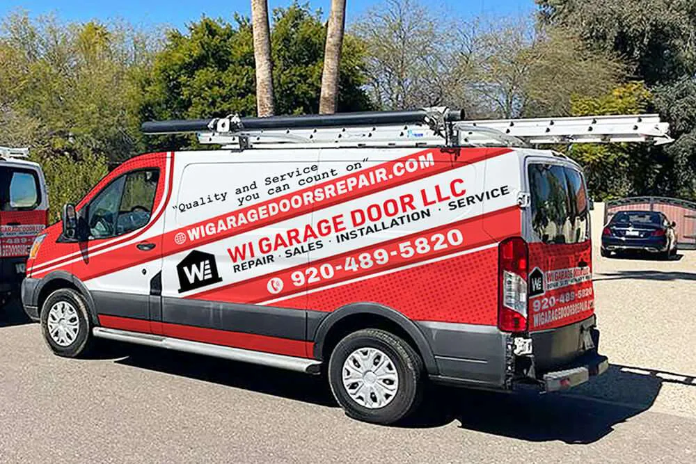 "A garage door service van parked outdoors, showcasing the WI Garage Door LLC branding with ladders on top, symbolizing service reliability."