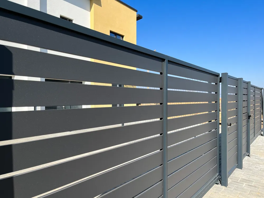 A sleek, modern metal gate under a clear blue sky, exemplifying the craftsmanship of Automatic Garage Door Corporation in San Francisco.