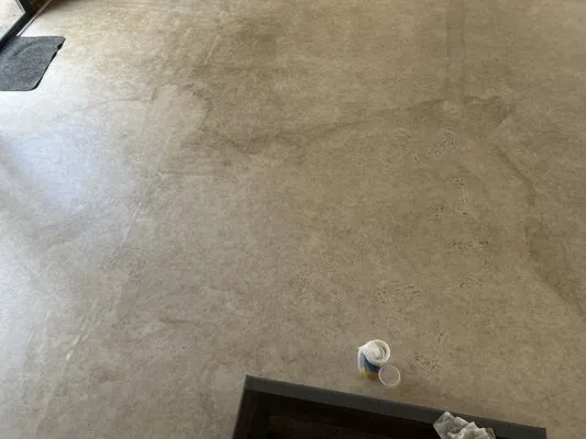 A clean floor with a small cleaning product and cloth nearby, showcasing the cleaning results achieved by BA House Cleaning in Castro Valley.