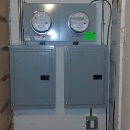 Two electrical panels and meters installed on a wall by BV Electric Inc. in San Francisco.