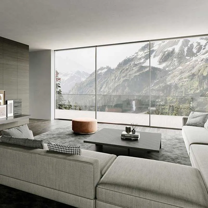 A modern living room with large floor-to-ceiling windows showcasing stunning mountain views, featuring sleek furniture and minimalist decor.