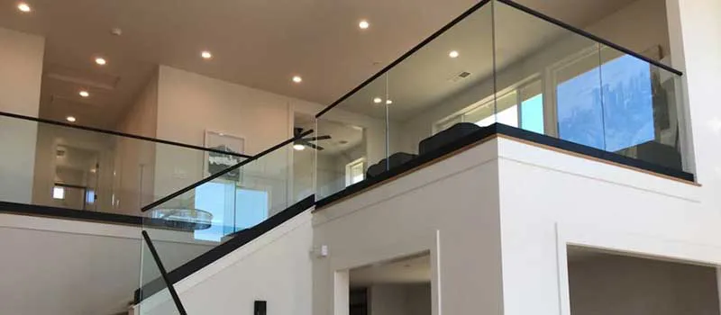 Modern interior staircase with sleek glass railings by B & L Glass in Santa Rosa, highlighting a spacious, well-lit room.