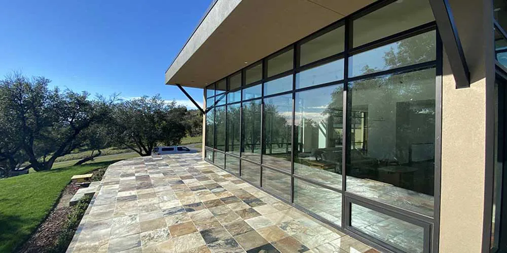 Modern building with expansive glass windows by B & L Glass, set against a scenic outdoor view in Santa Rosa.