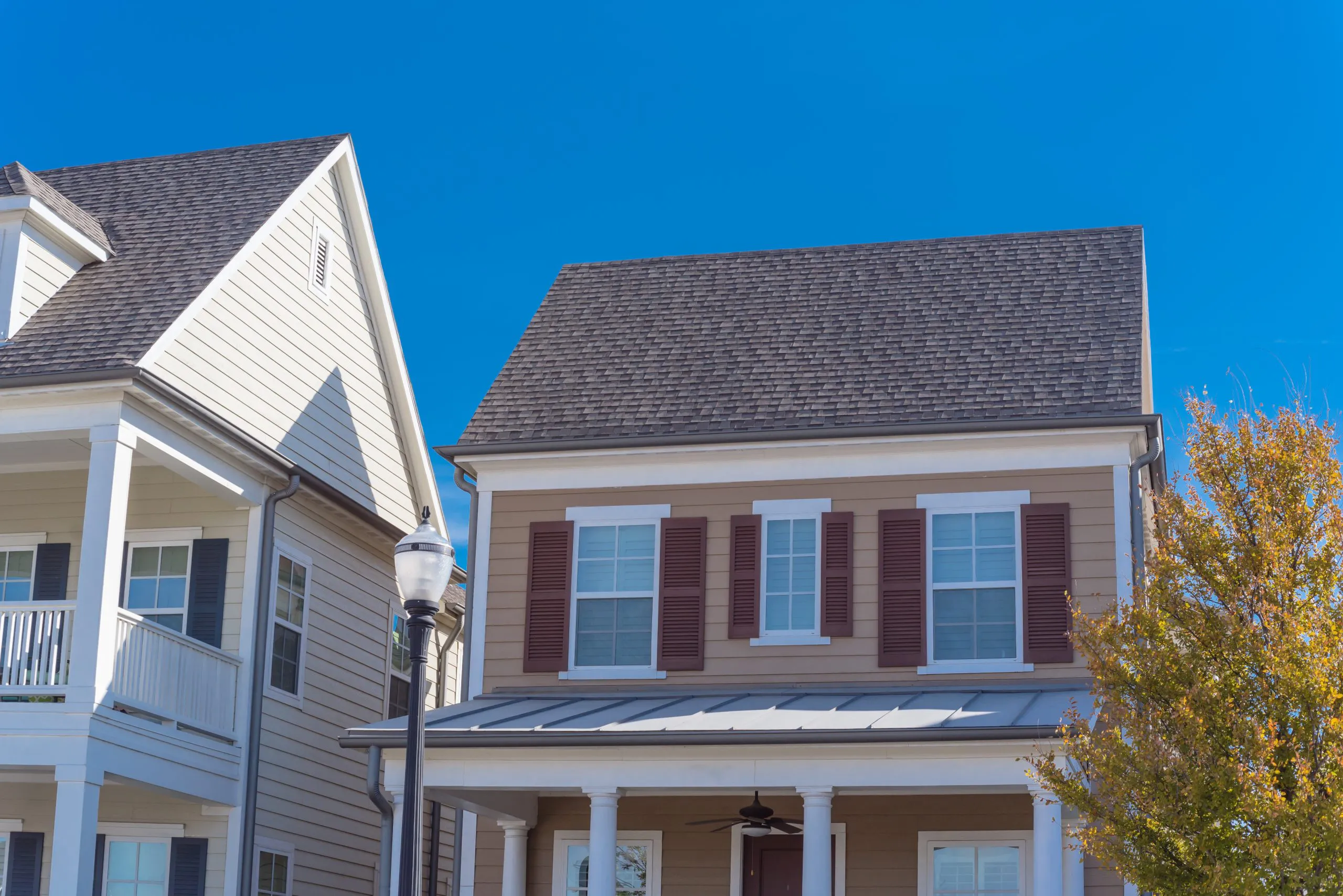 "A well-maintained house with a new roof by Bay 101 Roofing, Inc. in Alviso, under a clear blue sky."