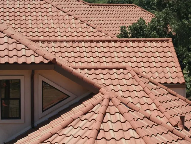 Multiple sections of a house roof featuring red ceramic tiles installed by Bay Valley Roofing in Concord.
