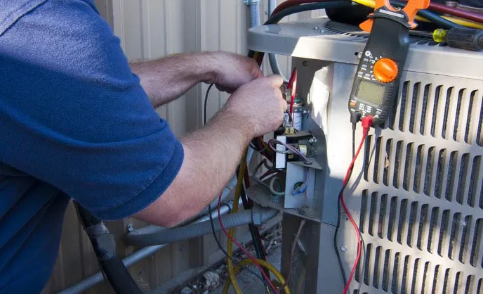 A technician working on an HVAC unit with wires and a multimeter, representing Bell Products, Inc. in Napa.