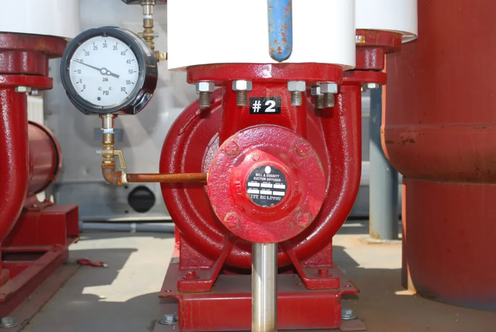 Close-up image of a red pump system labeled "2" with a pressure gauge, part of Bell Products, Inc.'s offerings in Napa.