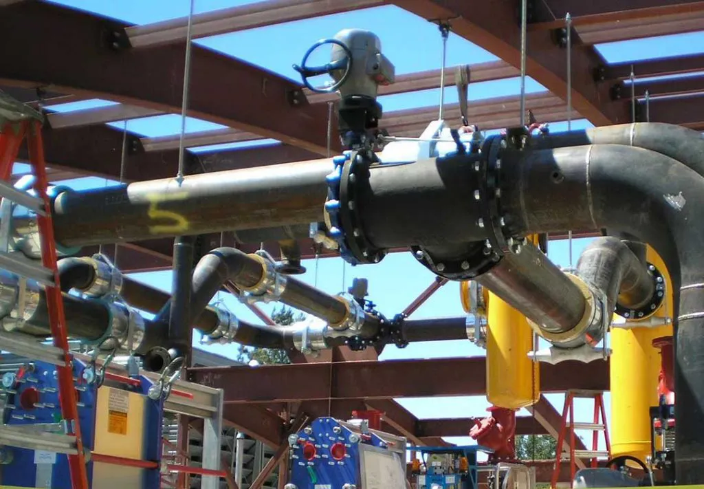A complex network of industrial pipes and fittings under construction at Bell Products, Inc. in Napa, showcasing the company's focus on precision and engineering excellence.