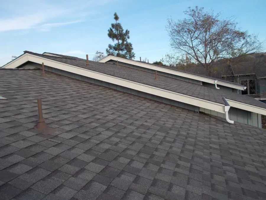 A newly shingled roof with multiple peaks and vents, showcasing the craftsmanship of Ben's Roofing, Inc. in Oakland.