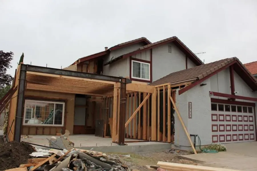 "A house under construction, featuring a new wooden framework added to the front, by Best Construction in San Jose."