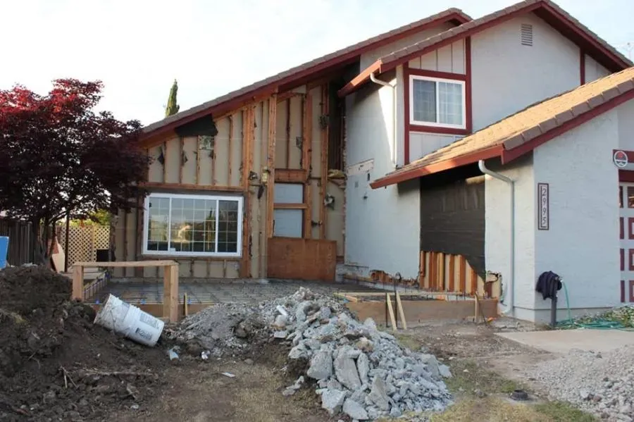 Partially renovated house with exposed wooden framing and construction materials, showcasing ongoing work by Best Construction in San Jose.