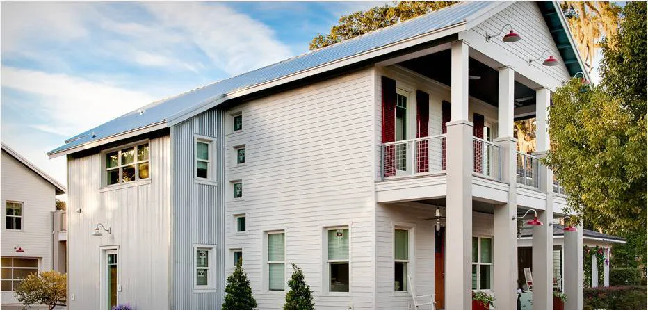A modern two-story house with a metal roof, large windows, and a balcony, showcasing the work of Best Exteriors Construction, Inc. in Rocklin.