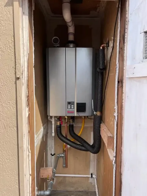 A cutting-edge water heater installed in a small enclosure, showcasing advanced technology by Better Water Heaters, Inc. in San Jose.