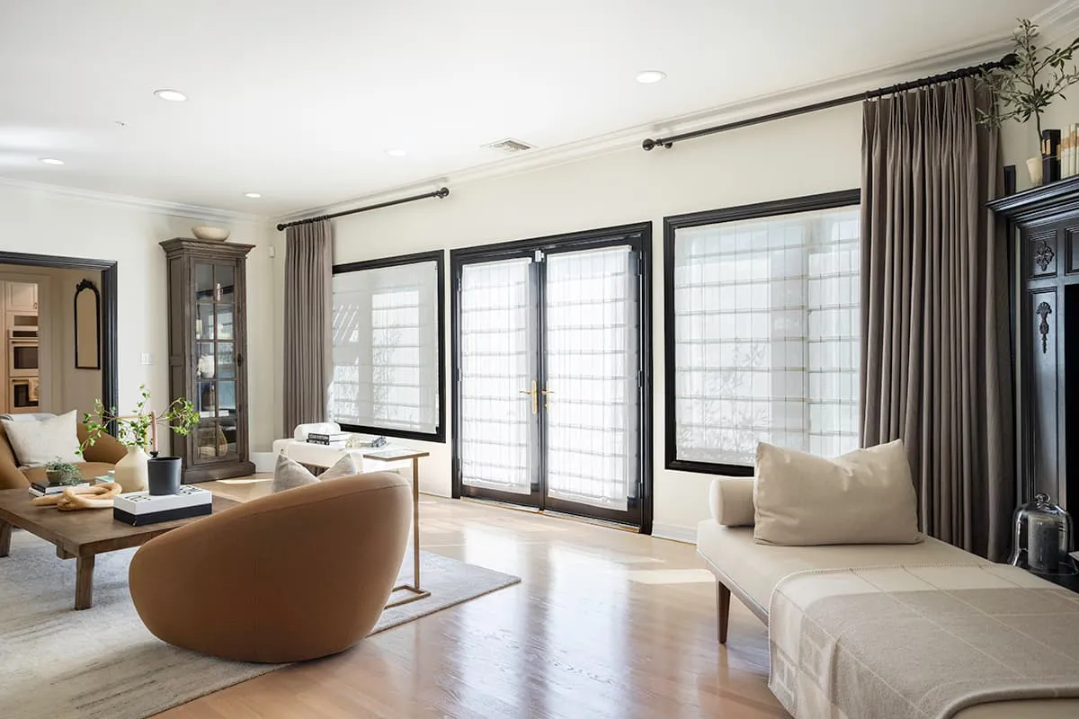 A modern living room in Rohnert Park featuring elegant window treatments with sheer blinds and curtains from Budget Blinds of Central Marin and South Marin.