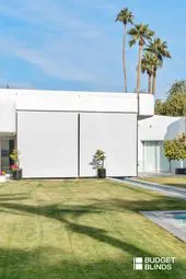 Contemporary home exterior featuring large white blinds from Budget Blinds of Central Marin and South Marin, showcasing minimalist design in Rohnert Park.
