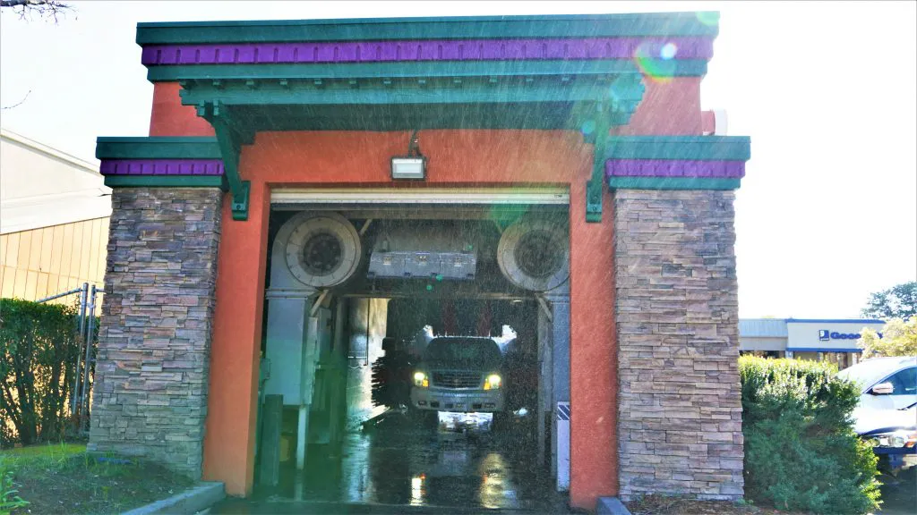 "A car going through an automated car wash facility with colorful detailing by CG Coatings Inc in Fairfield."
