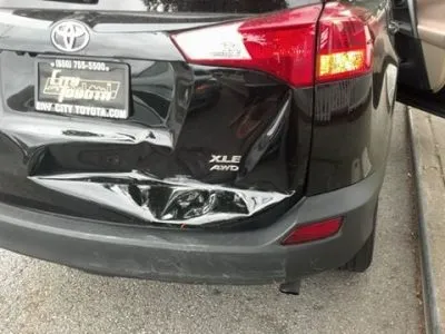 A black SUV with significant rear-end damage, showcasing the need for repair services at Cal Auto Body in Daly City.