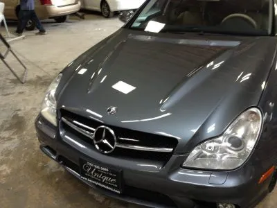 A polished Mercedes-Benz car in an auto body shop, highlighting professional repair work.
