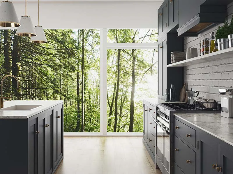 A modern kitchen with dark cabinets and a large window showcasing a lush forest view, designed by Cal Summit Builders in San Rafael.