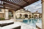 Luxurious outdoor area in Discovery Bay featuring a spacious pool, elegant architecture, and a pergola with lounge seating, designed by California Aqua Pros.
