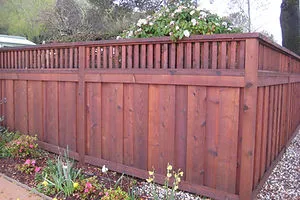 Wooden fence with vertical slats and a planter on top, constructed by California Fencing Company in San Rafael.