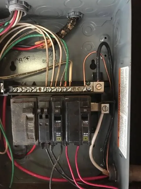 Close-up of an electrical panel showing circuit breakers and wiring, emphasizing the importance of safety and reliability at California Power and Light in Morgan Hill.