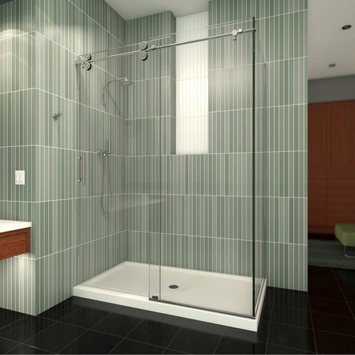 A contemporary glass shower enclosure with sliding doors in a modern bathroom, featuring striped green wall tiles and a dark floor, designed by California Shower Door Corporation.