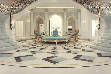 A grand, elegantly designed foyer with a symmetrical staircase and luxurious sitting area, showcasing premium interior design elements.